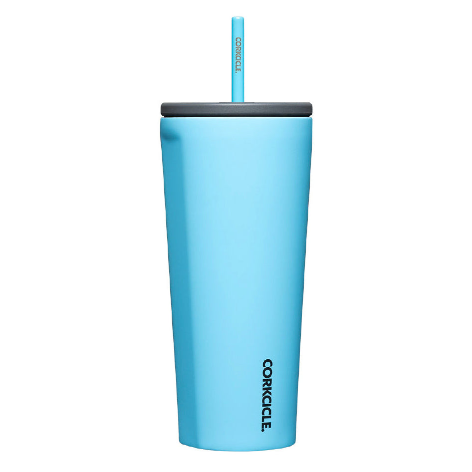 Blue tumbler with a straw on a white background